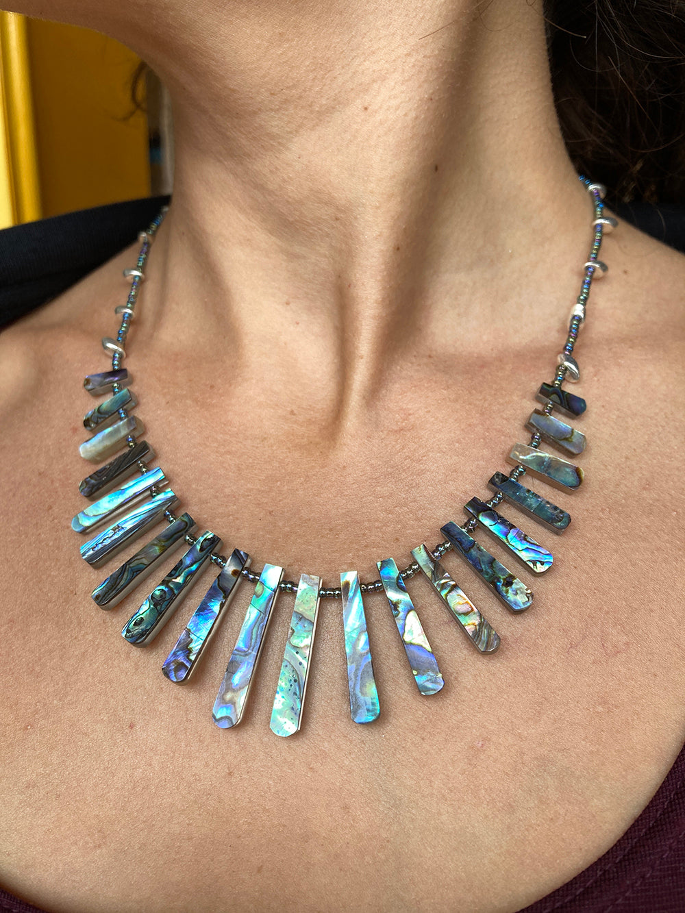 abalone necklace on woman's neck. Handmade by Heather Sood founder of Kala Roopa